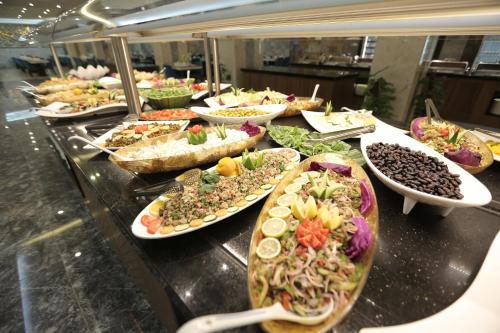 a buffet line with many different types of food at Qasr AlDur Hotel in An Najaf