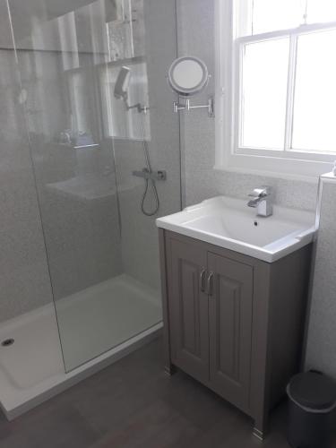 a bathroom with a shower and a sink and a toilet at New Hall Bank in Bowness-on-Windermere