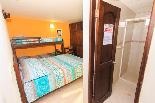 a small bedroom with a bed and a closet at Hotel Marovi in Santa Marta