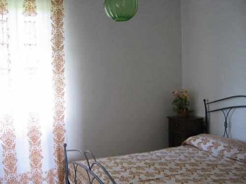 a bedroom with a bed and a window at La Fattoria in Santarcangelo di Romagna