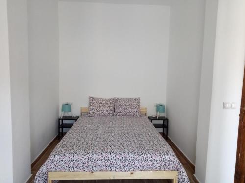 a bed in a room with two night stands at Sofia's Flat in Valencia