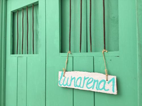 a sign that saysunnamed hanging on a door at LunArena Barefoot Comfort in El Cuyo