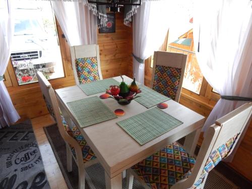 a dining room table with a bowl of fruit on it at Villa Evelia in Aquitania