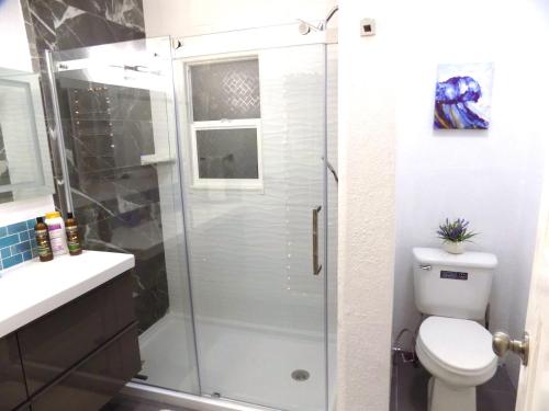 a bathroom with a shower with a toilet and a sink at Casa San Diego in San Diego