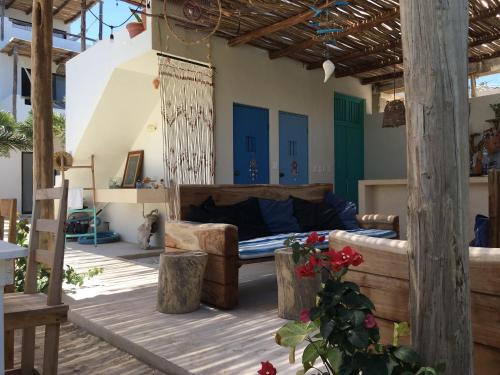 a bedroom with a bed on a patio at LunArena Barefoot Comfort in El Cuyo