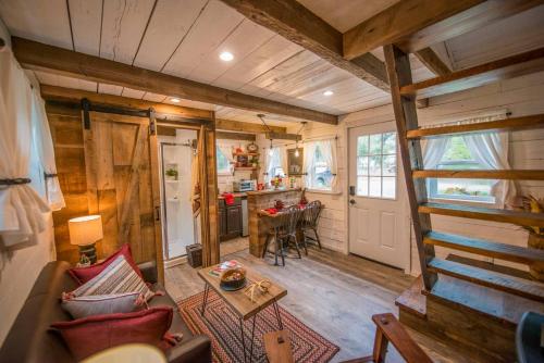 a living room and kitchen in a tiny house at Cozy Cabin Little Red Hen 12 min to Magnolia in Waco