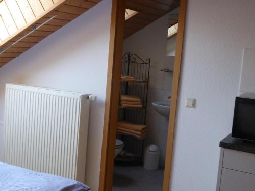a bathroom with a toilet and a staircase in a room at Roth Apartments beim Europa-Park Rust in Rheinhausen