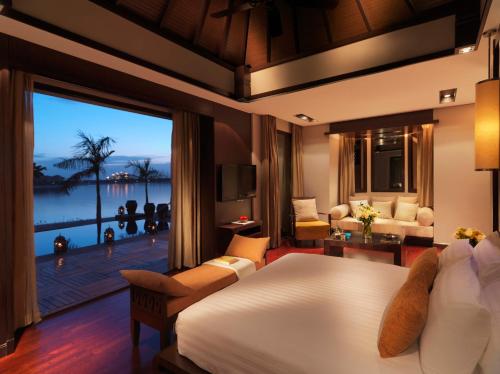 a bedroom with a bed and a view of the ocean at Anantara The Palm Dubai Resort in Dubai
