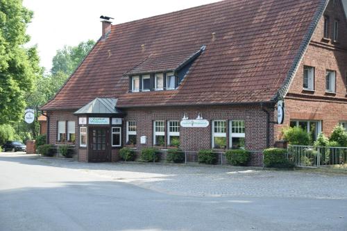 a red brick building with a brown roof at Gasthof Waldesruh in Saerbeck