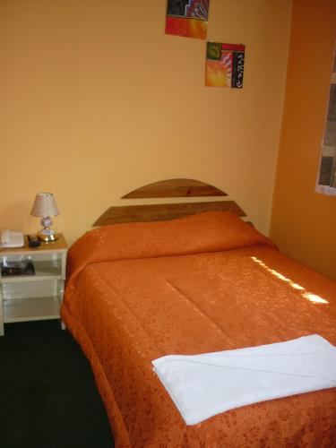 a hotel room with a bed with a white towel on it at Hostal Los Balcones de Moral y Santa Catalina in Arequipa