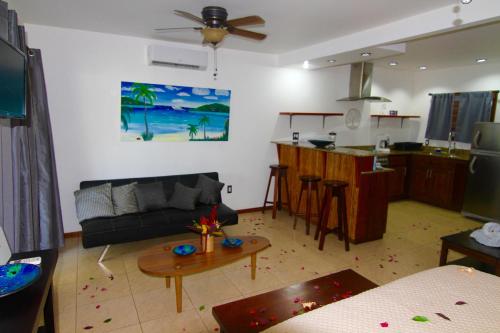 a living room with a couch and a table at mame trees in West End