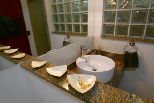 a bathroom counter with a sink and a mirror at mame trees in West End