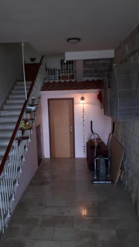 a hallway with stairs and a door in a house at Apartment Astoria in Krilo
