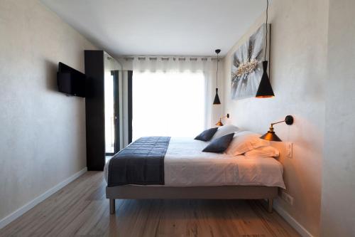 a bedroom with a bed and a large window at Residence Provencal - Luxurious - 300m Palais - LRA CANNES in Cannes