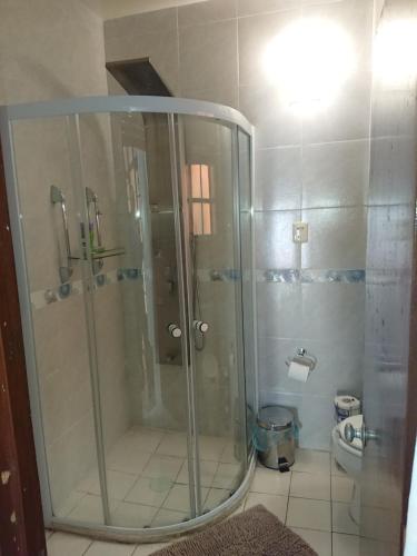 a glass shower in a bathroom with a toilet at Suite Vintage in Puebla