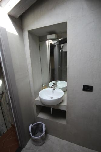 a bathroom with a sink and a mirror at Dimora Carducci in Pietrasanta