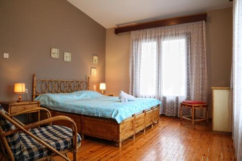 a bedroom with a bed and a window at Villa Christie in Keramoti