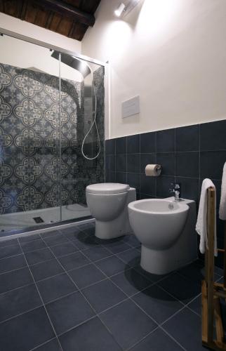 a bathroom with a toilet and a shower at Bed in Spa in Palermo