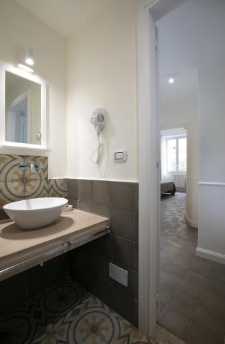 a bathroom with a sink and a mirror at Bed in Spa in Palermo