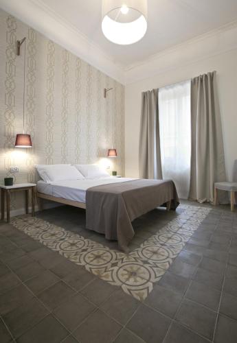 a bedroom with a bed and two lamps in it at Bed in Spa in Palermo