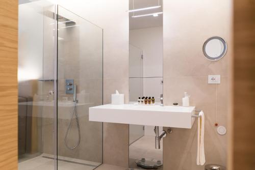 a bathroom with a sink and a shower at Posia Retreat & Spa UNA Esperienze in San Foca