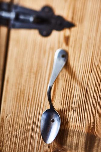a spoon sitting on top of a wooden table at Hotel Garni Eder in Gmund am Tegernsee