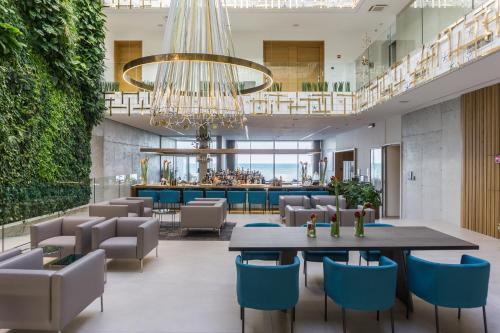 a lobby with a table and chairs and a bar at Posia Retreat & Spa UNA Esperienze in San Foca