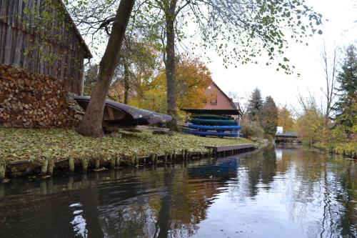 a river with a house and a boat on it at Appartement Dachgeschoss in Schlepzig