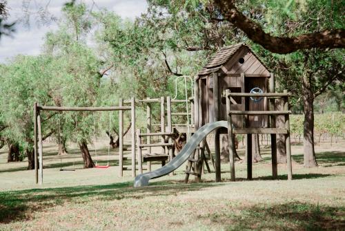 a playground in a park with a slide at Tranquil Vale Vineyard in Luskintyre