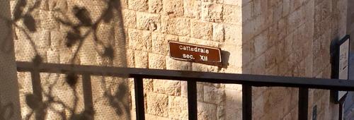 a sign on the side of a brick wall at Palazzo Framarino dei Malatesta - Noble Floor - XIV Century in Giovinazzo