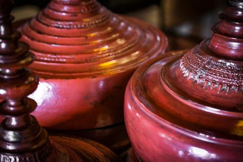 
a row of vases sitting on top of a table at Imperio De Angeles in San Miguel de Allende
