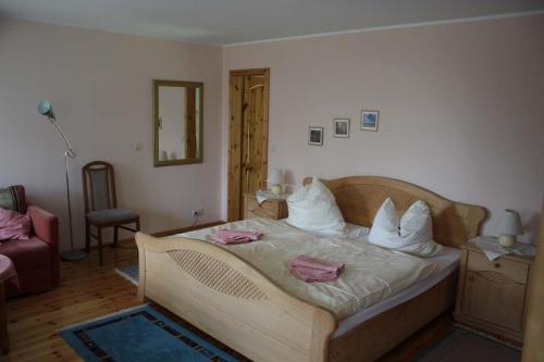 a bedroom with a bed with white sheets and pillows at Apartment in Schwielochsee OT Guhlen 36012 in Guhlen