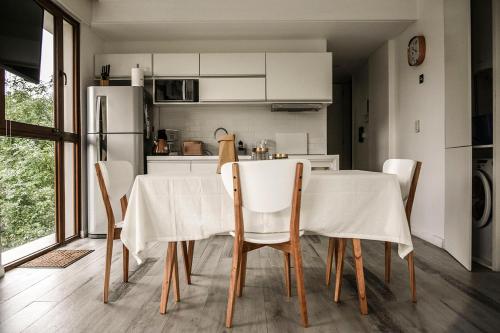 a kitchen with a table with chairs and a refrigerator at Aizarker in La Plata
