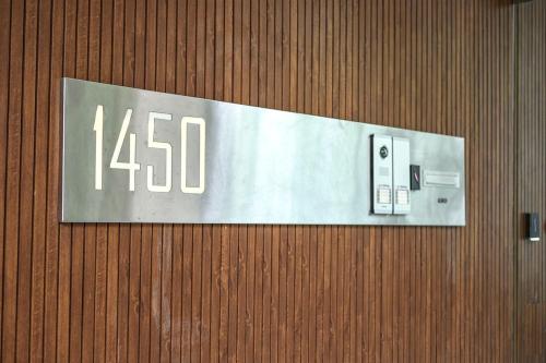 a sign on a wooden wall with the number at Aizarker in La Plata