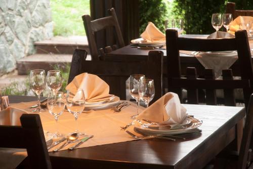 a table with wine glasses and napkins on it at Villa Mukinja - Wellness & Spa in Plitvička Jezera