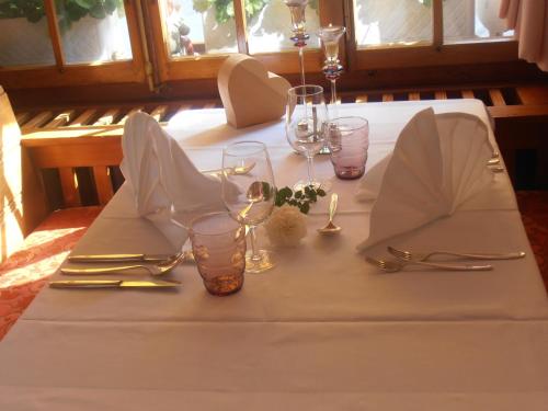 a table with a white table cloth and glasses and silverware at Hotel Restaurant Escher in Leukerbad