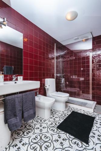 a bathroom with a toilet and a sink and a shower at Fortaleza do Pico Apartment in Funchal
