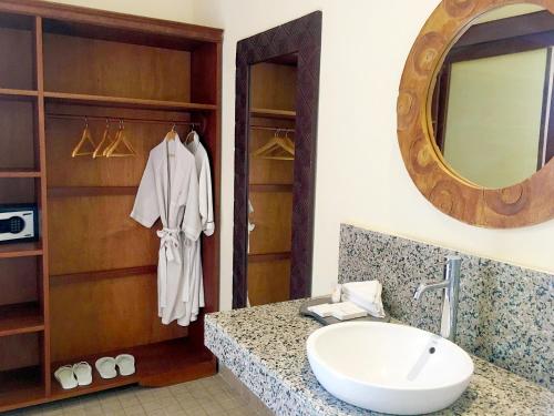 a bathroom with a sink and a mirror at Villa with private pool at Villa Nirvana Ubud in Ubud
