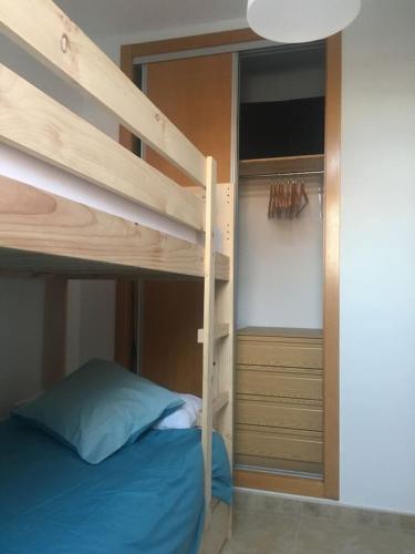 a bedroom with a bunk bed with a ladder and a closet at Apartamento Ahola in Archena