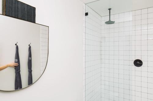 a mirror in a bathroom with two umbrellas at Silver Lake Pool & Inn in Los Angeles