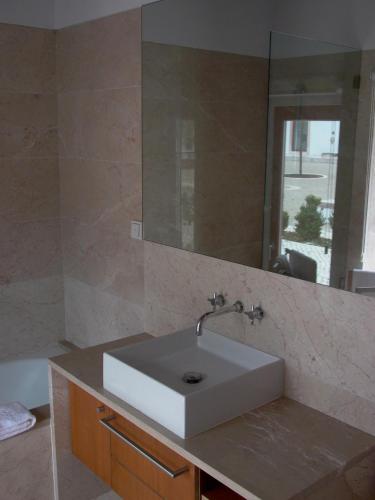 a bathroom with a white sink and a mirror at Quinta da Lapa in Manique do Intendente