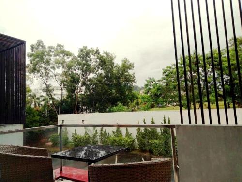 a patio with a table and chairs on a balcony at The Centro Hotel & Residence By Orchardz in Batam Center