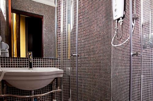 فندق فالينتسا في كوالالمبور: حمام مع حوض ودش مع مرآة