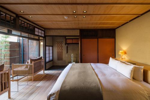 a bedroom with a large bed in a room at Nazuna Kyoto Gosho in Kyoto