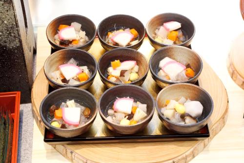 a bunch of small cups of food on a table at Hotel Hokke Club Niigata Nagaoka in Nagaoka