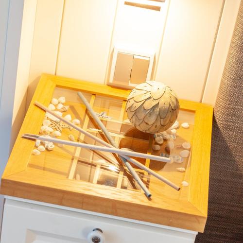 a wooden box with baseball equipment on top of a drawer at Hotel Vier Jahreszeiten Binz in Binz