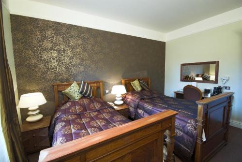 a bedroom with a bed and a couch at Scafell Hotel in Rosthwaite