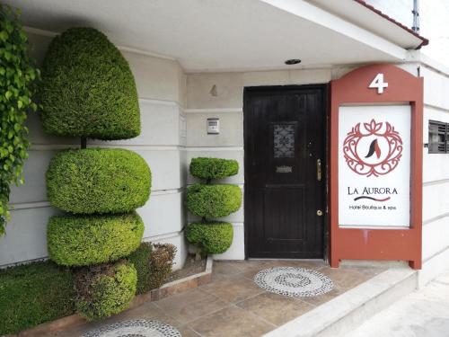 a front door of a building with a red door at La Aurora Hotel Like Home in Huamantla