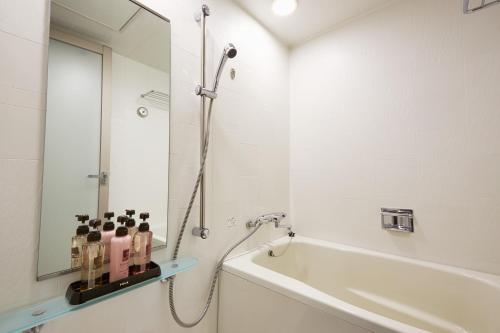 
a bathroom with a shower, sink, and tub at S Peria Hotel Nagasaki in Nagasaki
