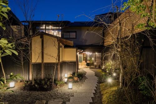 a courtyard of a house at night with lights at Nazuna Kyoto Gosho in Kyoto